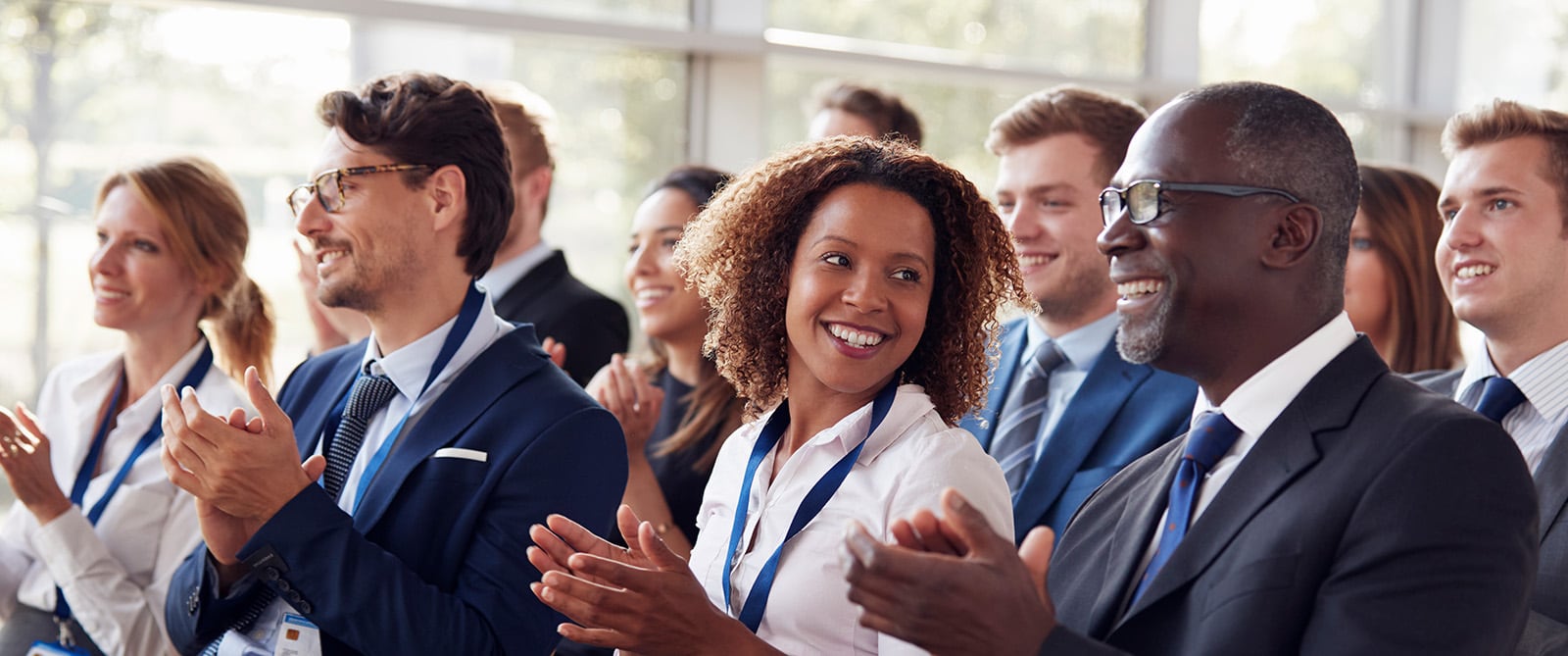smiling-audience-applauding-at-a-business-seminar